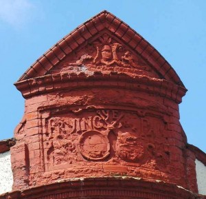 The tow crossed frying pans on the gable of the former Frying Pan Pub.