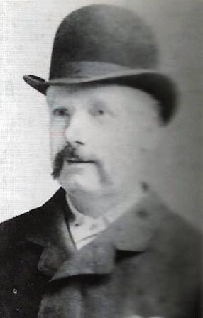 An image of George Lusk wearing a bowler hat.