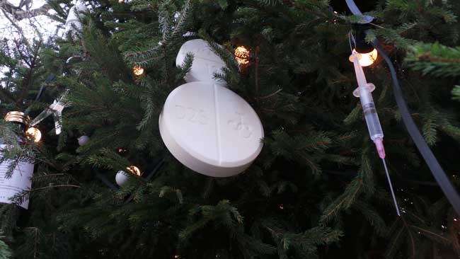 These decorations are a snowman made out of a white pill and a syringe.