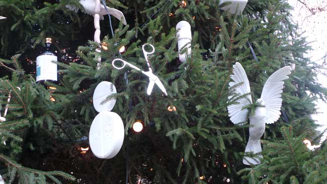 A series of decorations including scissors, a white bird and a pill snowman.