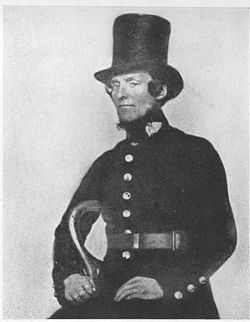 An early police onstable in a top hat and his blue uniform.
