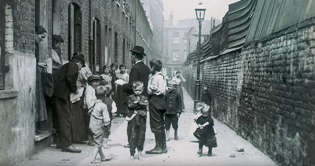 Missionaries visiting the residents of a London slum in the 19th century. 