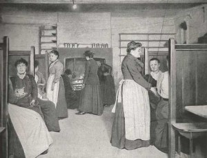 Women sit at tables in a Common Lodging House Kitchen
