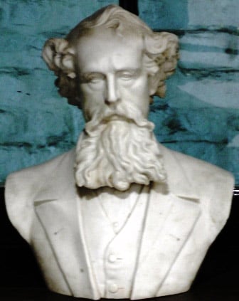 A white marble bust of Charles Dickens.
