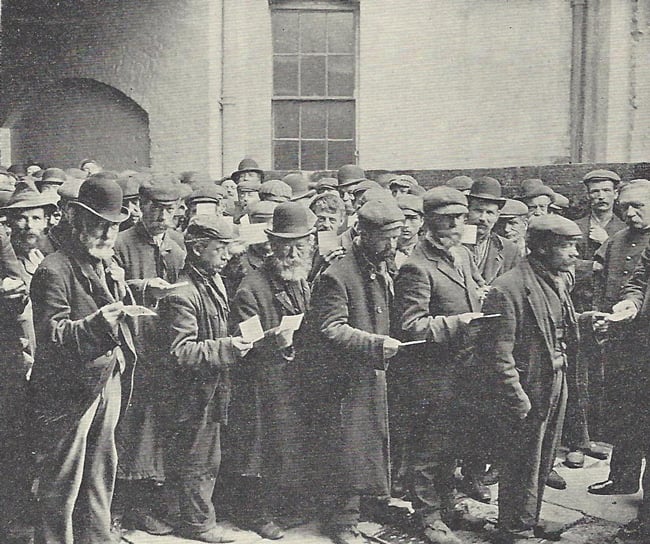 A group of homeless men gather in the Salvation Army yard.