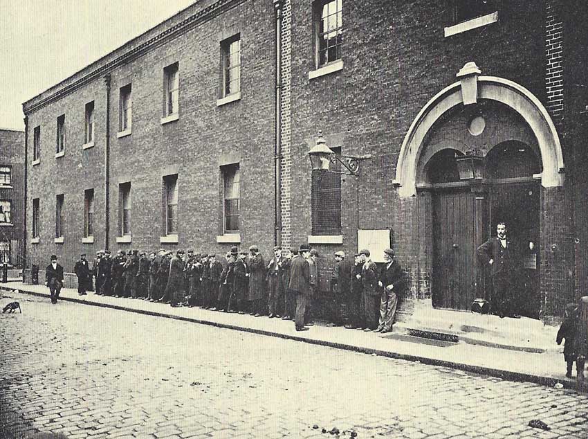 A group gather outside the Workhouse.