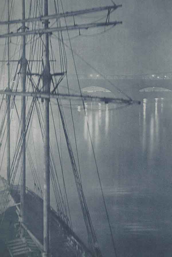 The mast of a ship seen in a fog on the River Thames.