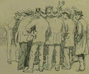 Men listening to a speaker in the square.