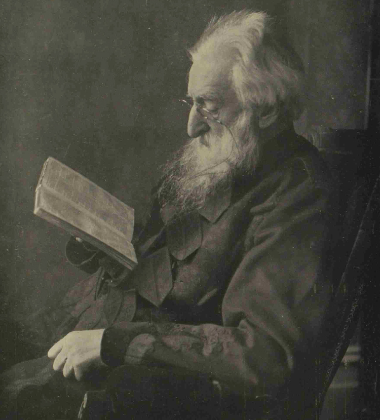 A photograph showing General Booth reading a book.