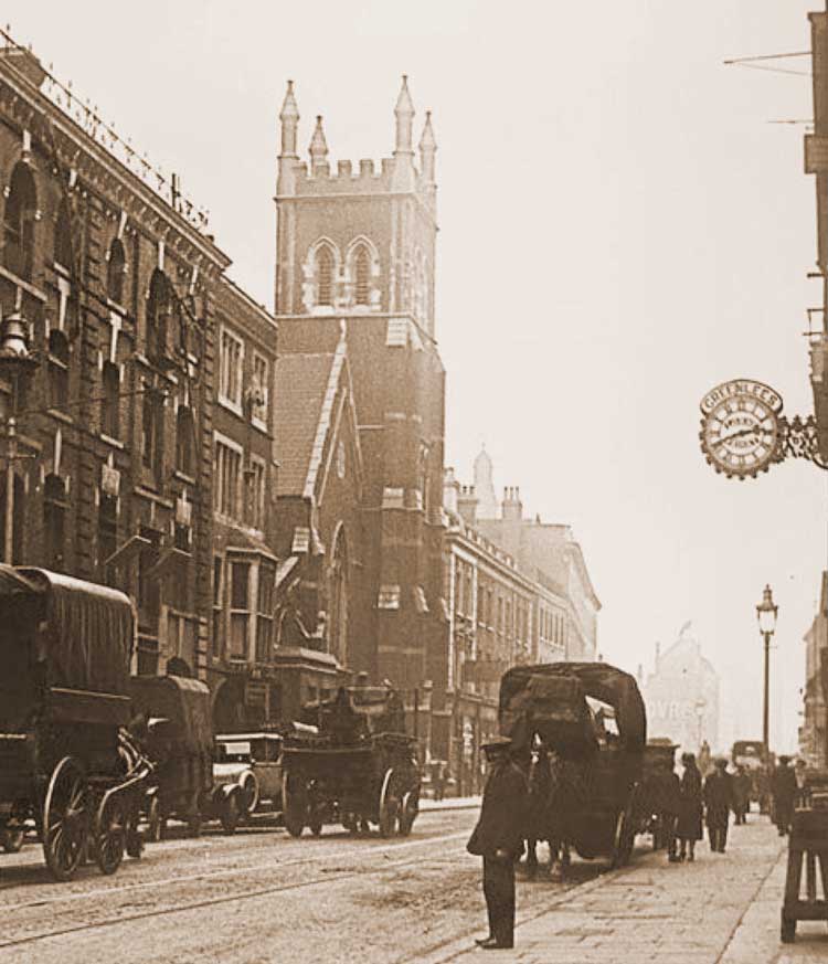 A photograph of Commercial Street, showing St Jude's Church.