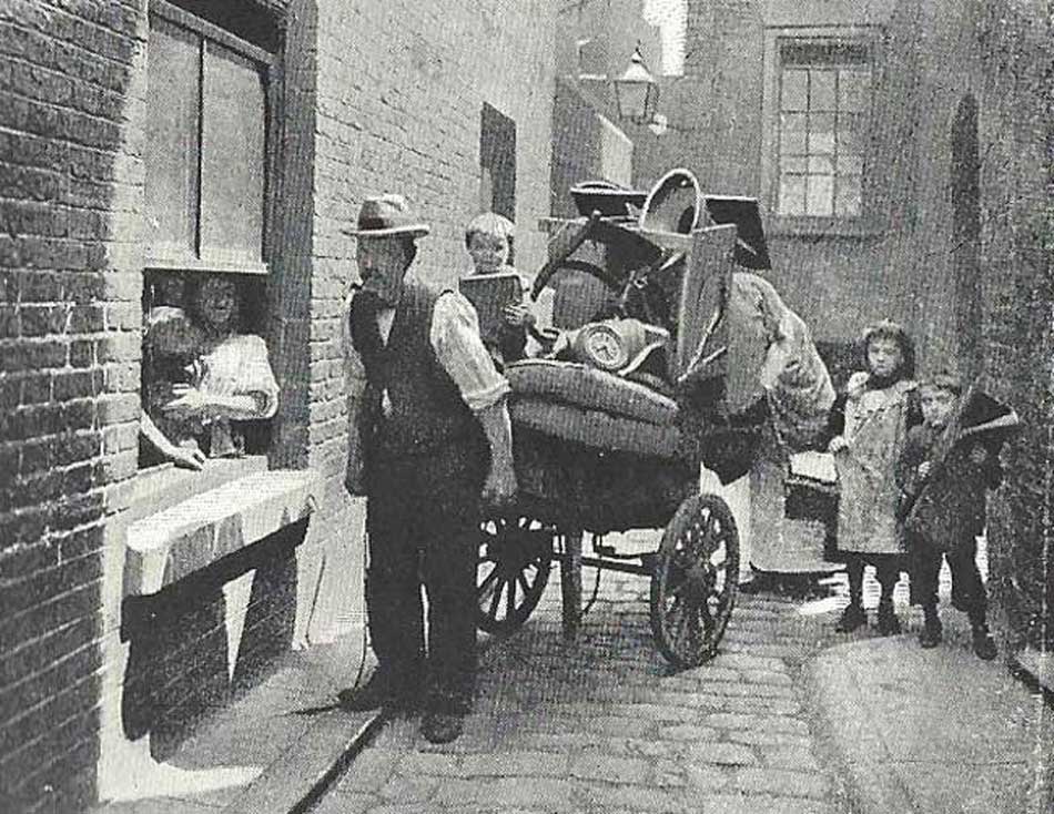 A family with thier possessions on a cart move house.