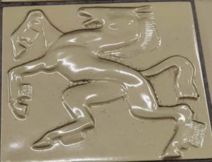 A rearing horse on a tile.